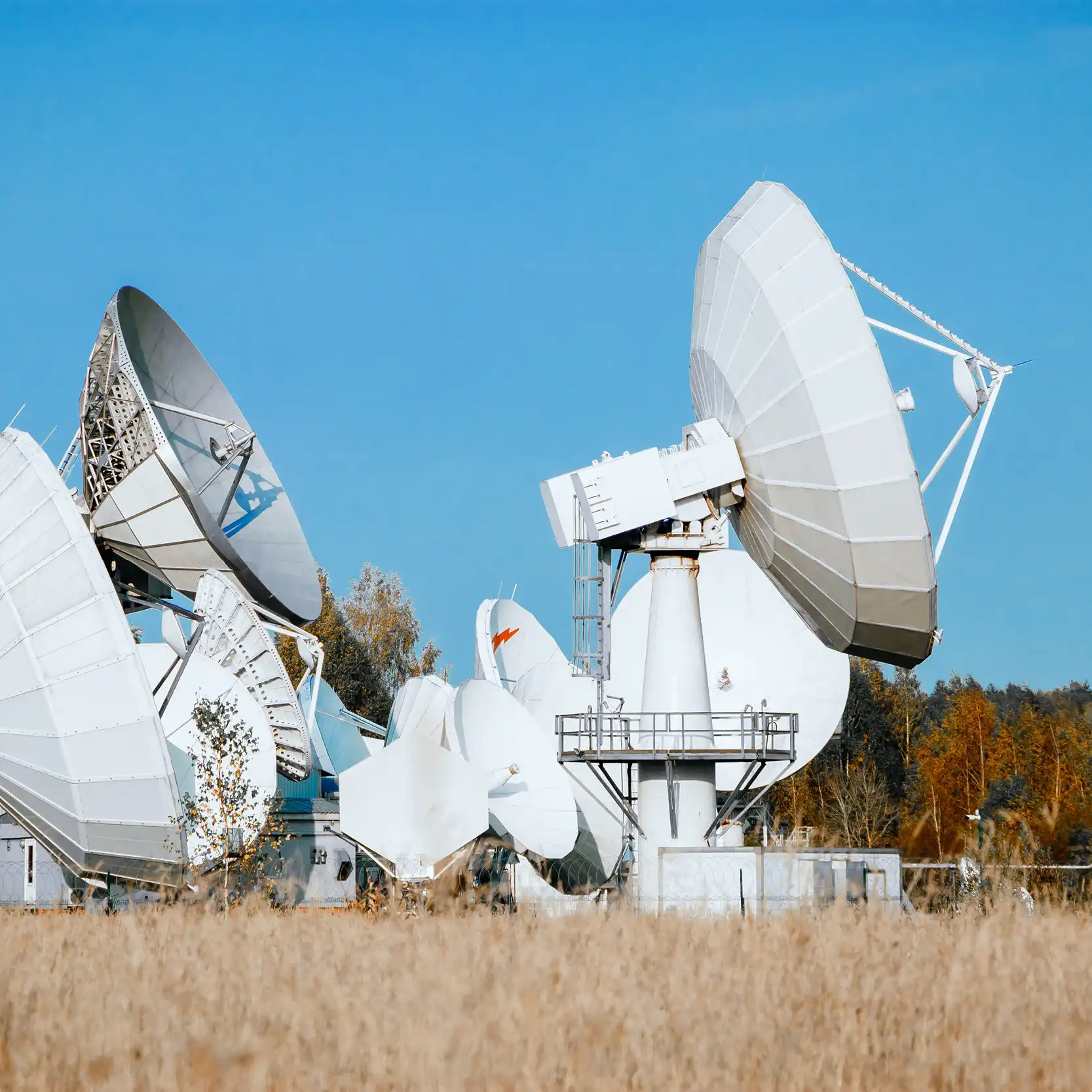 Satellite communication dishes representing AI-powered telecom infrastructure and connectivity